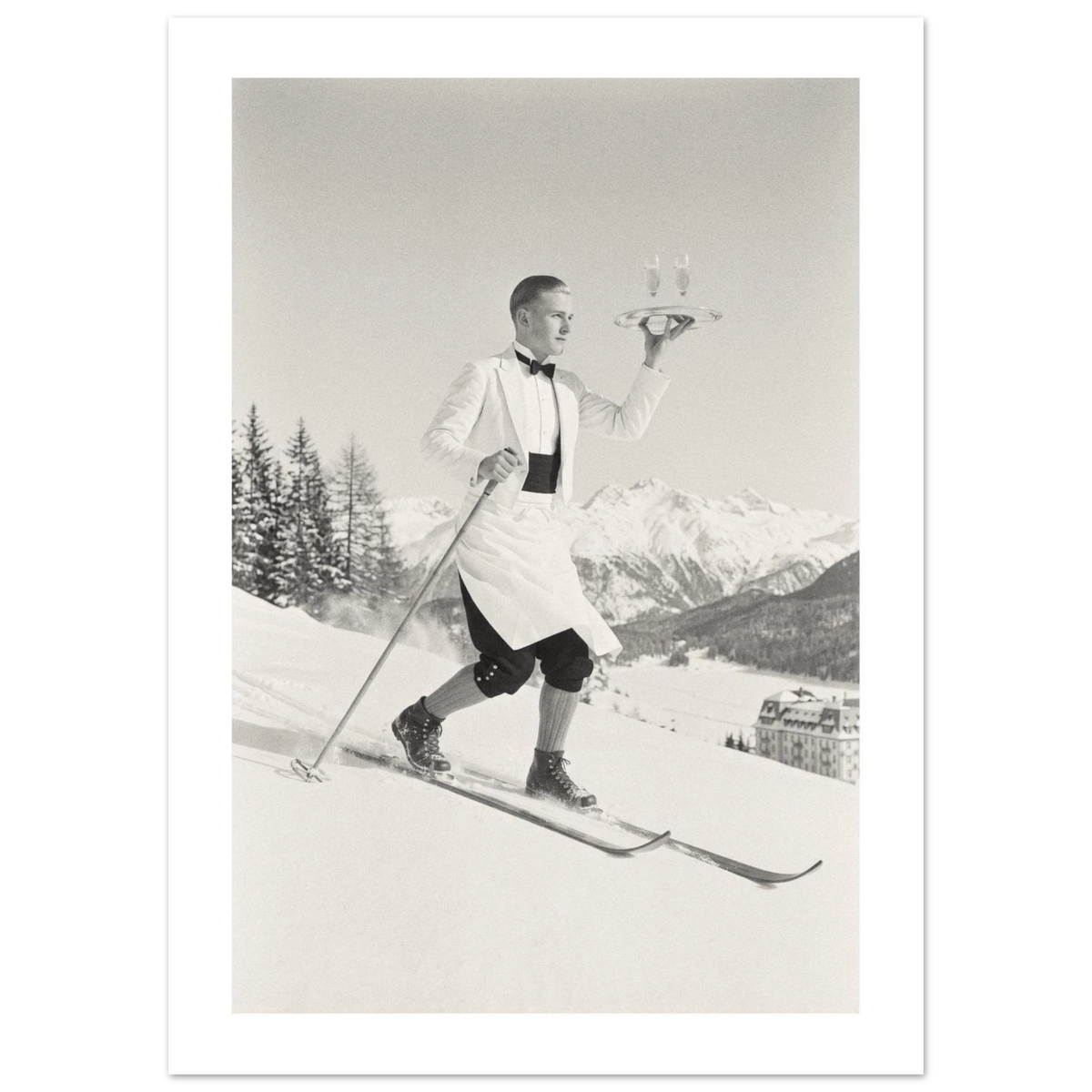 Ski waiter in white jacket skiing downhill with a tray of champagne, 1930s style black and white photo print