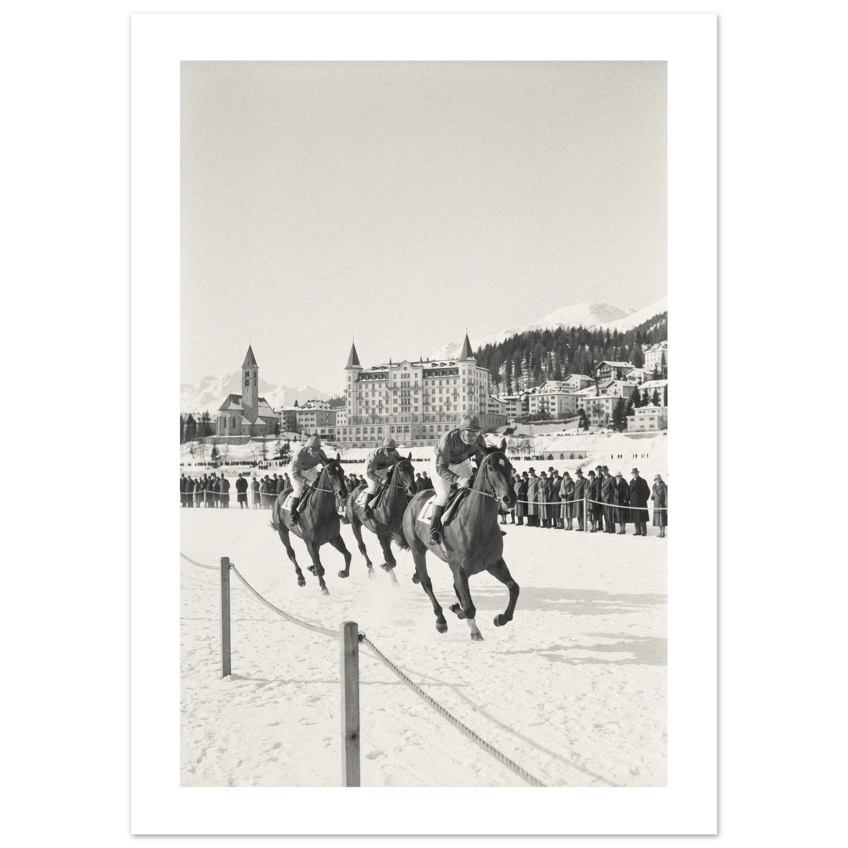 Racehorses and jockeys galloping on a frozen alpine lake with spectators and mountains, 1932 style black and white photo print