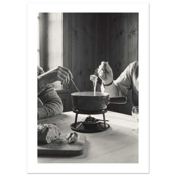 Couple dipping bread into a cheese fondue at a wooden table in a Swiss chalet room, 1932 style black and white photo print